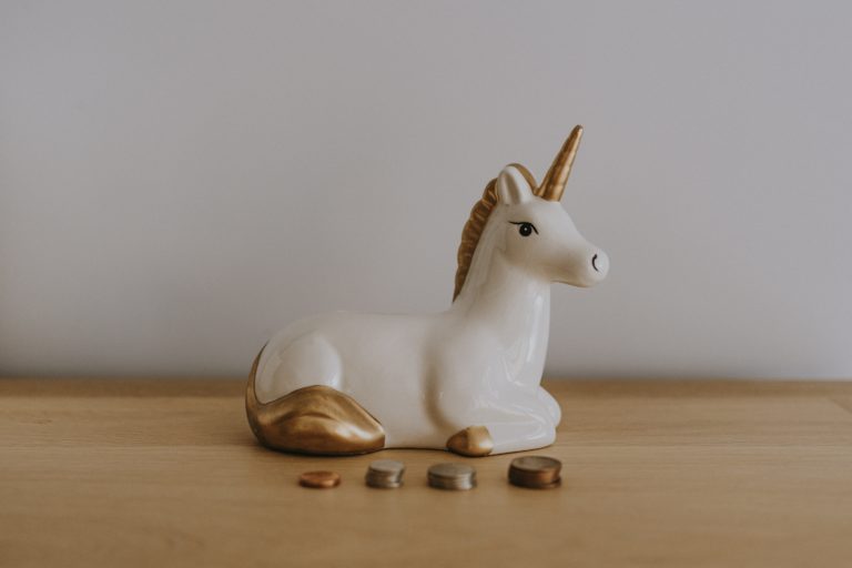 Unicorn Next to Stack of Coins